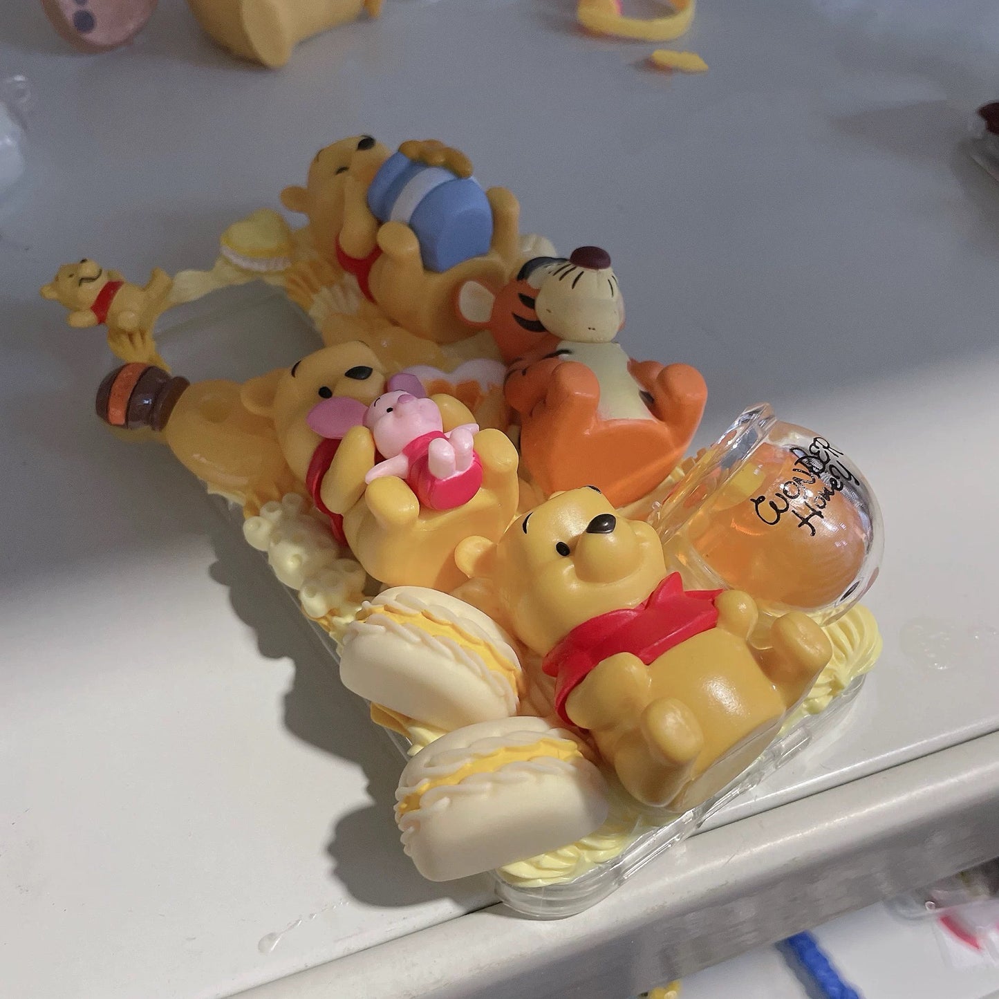 Phone case with cartoon figures ( Winnie the Pooh)
